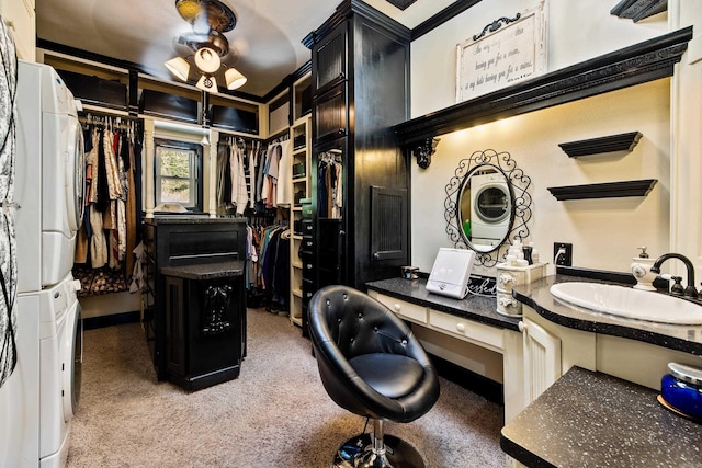 interior space featuring stacked washer and clothes dryer, light carpet, and a sink