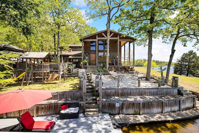 deck with a water view and a playground