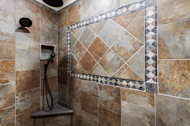 bathroom with tiled shower