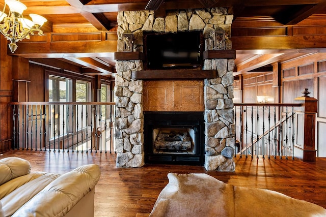 living area featuring an inviting chandelier, beam ceiling, wood walls, wood ceiling, and hardwood / wood-style floors