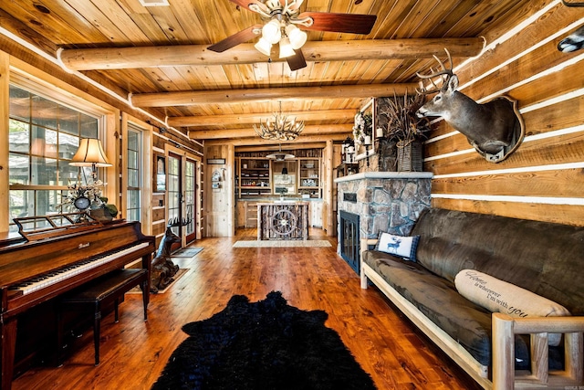 interior space with ceiling fan, beam ceiling, hardwood / wood-style flooring, and wood ceiling