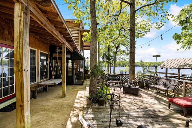 view of patio / terrace with a deck with water view and an outdoor living space