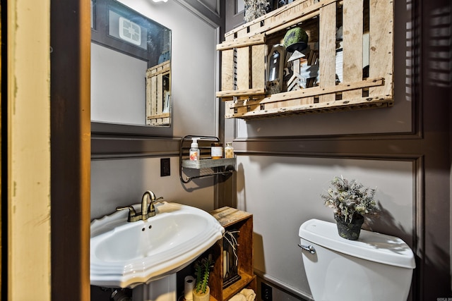 bathroom featuring toilet and a sink