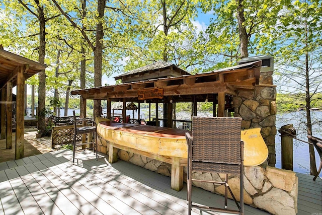 deck with a gazebo, outdoor dry bar, and a water view