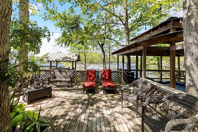 deck featuring a gazebo and a water view