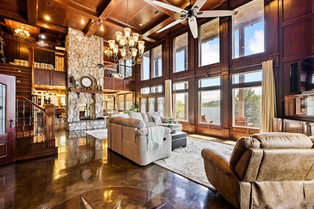 living area featuring stairs, coffered ceiling, wood ceiling, ceiling fan with notable chandelier, and beam ceiling