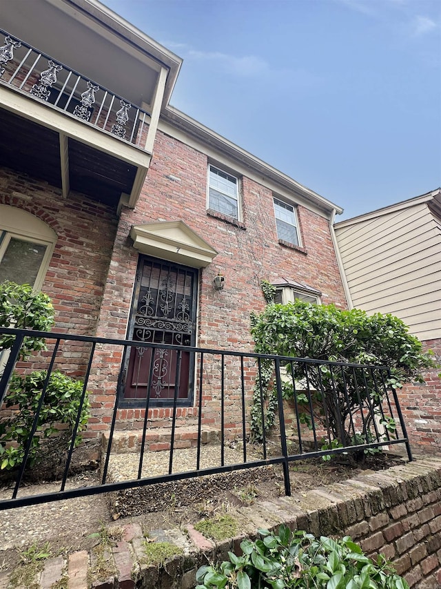 1919 Georgia Unit 7, Little Rock, AR 72207 - view of exterior entry featuring a balcony and brick siding
