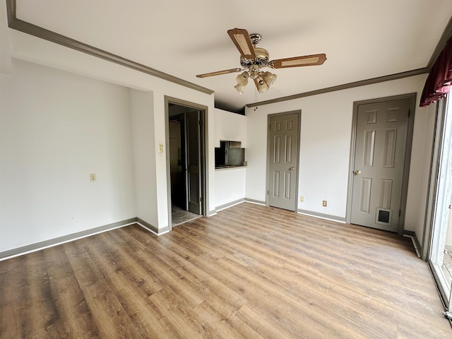 1919 Georgia Unit 7, Little Rock, AR 72207 - unfurnished bedroom featuring baseboards, a ceiling fan, light wood-style floors, and crown molding