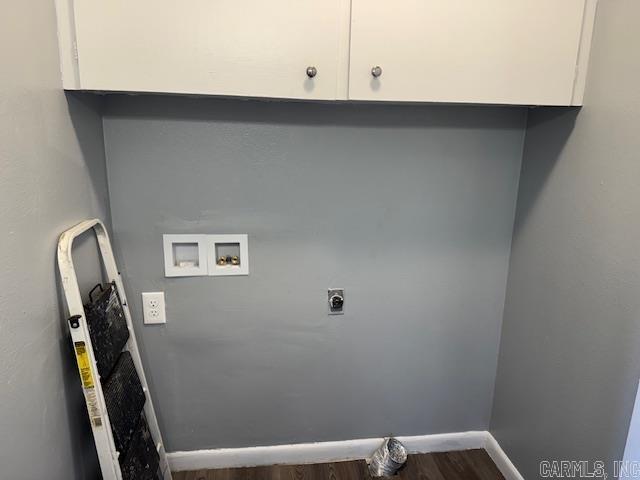 laundry room with hookup for an electric dryer, washer hookup, baseboards, dark wood-style flooring, and cabinet space
