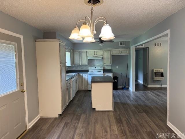 kitchen featuring under cabinet range hood, heating unit, a notable chandelier, white range with electric cooktop, and a textured ceiling