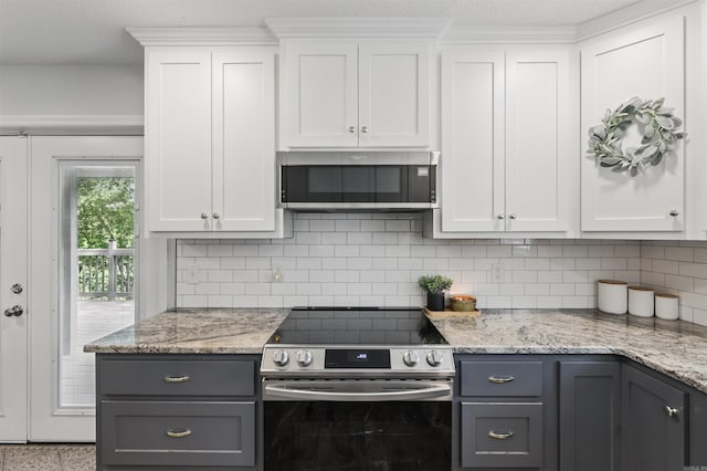 kitchen with decorative backsplash, white cabinets, gray cabinetry, and stainless steel appliances