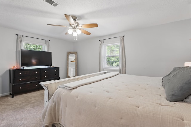 bedroom with ceiling fan, carpet, and visible vents