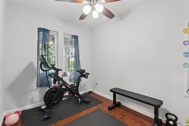 workout room featuring baseboards, ceiling fan, and wood finished floors