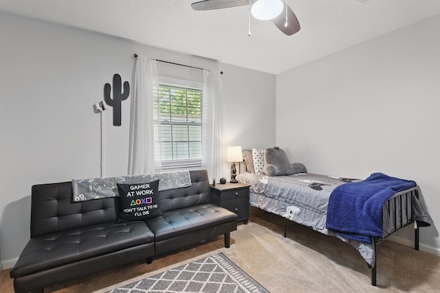 carpeted bedroom featuring baseboards and a ceiling fan
