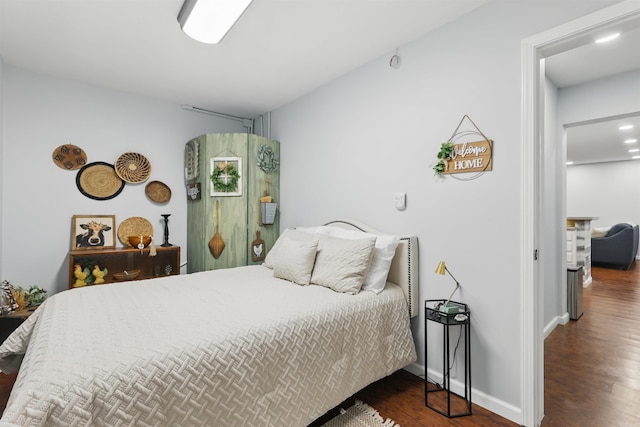 bedroom with baseboards and wood finished floors