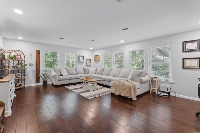 living room featuring dark wood-style flooring, recessed lighting, baseboards, and visible vents