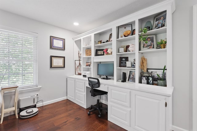 office space featuring built in study area, baseboards, plenty of natural light, and dark wood finished floors
