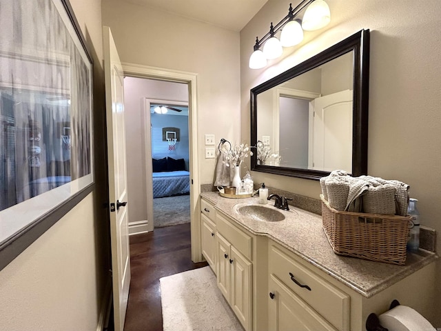 bathroom with vanity, baseboards, and finished concrete floors