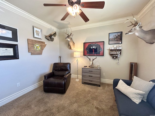 sitting room featuring baseboards, carpet flooring, a ceiling fan, and ornamental molding