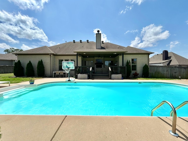 view of swimming pool featuring a fenced in pool, ceiling fan, fence, and a wooden deck