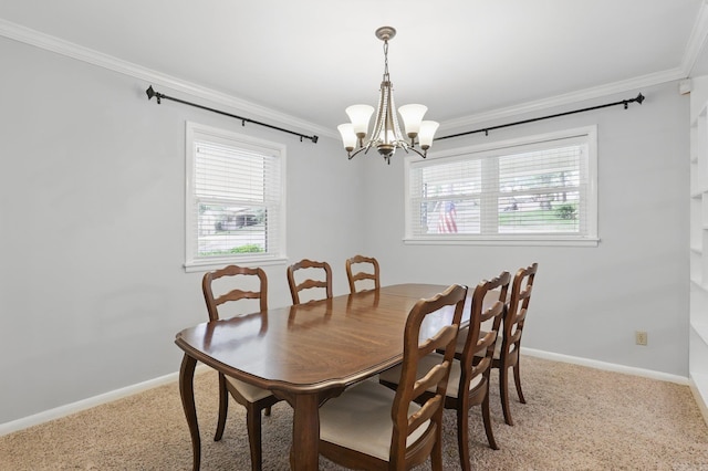 dining room featuring a chandelier, ornamental molding, and light carpet