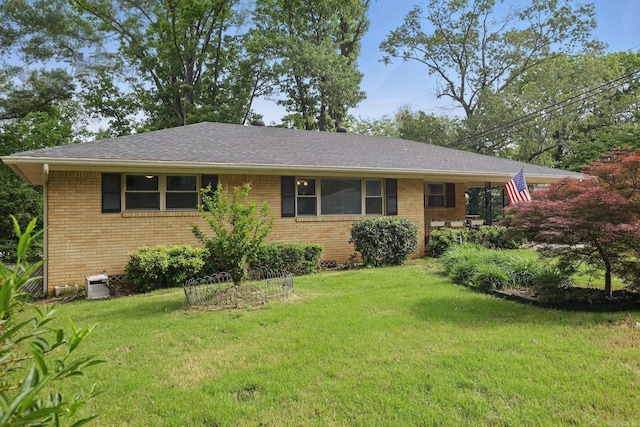 single story home featuring a shingled roof, brick siding, and a front lawn