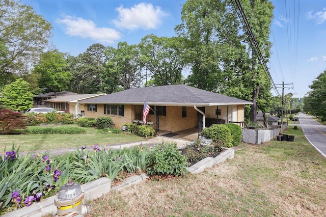 ranch-style home featuring brick siding and a front lawn