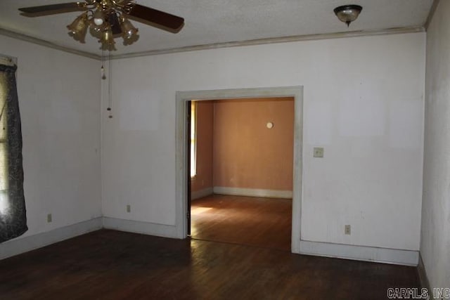 unfurnished room featuring ornamental molding, a ceiling fan, wood finished floors, and baseboards