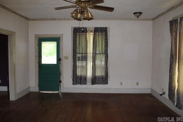 empty room with wood finished floors, ceiling fan, and ornamental molding