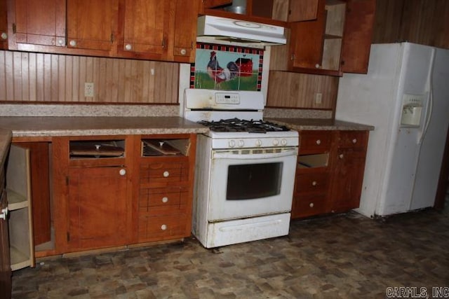 kitchen featuring white appliances, brown cabinetry, and under cabinet range hood