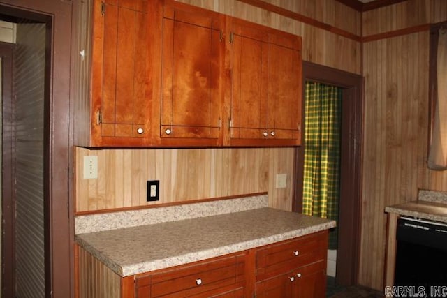 kitchen featuring black dishwasher, brown cabinets, and light countertops