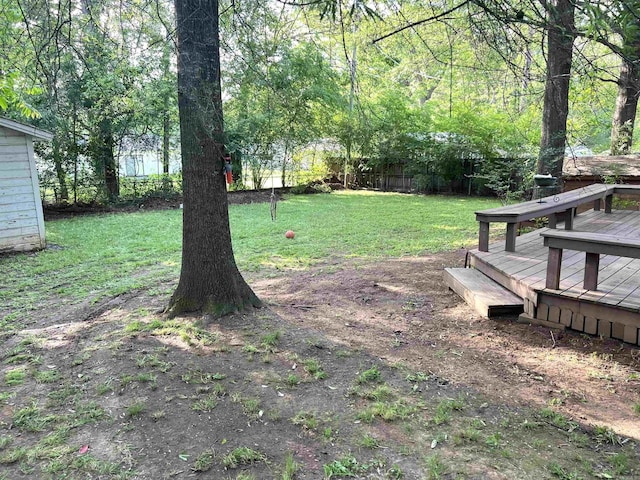 view of yard featuring fence and a wooden deck