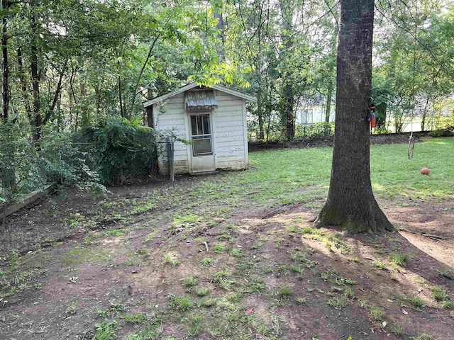 view of yard with fence and an outdoor structure