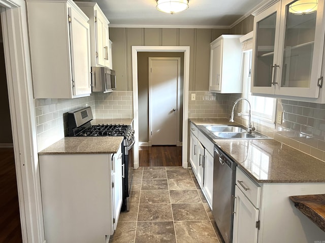 kitchen with white cabinetry, stainless steel appliances, and a sink