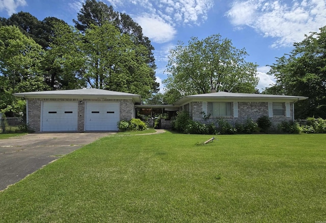 604 N Grand Ave, Mcrae, AR 72102 - ranch-style house featuring a garage, brick siding, a front lawn, and driveway