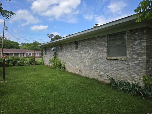 604 N Grand Ave, Mcrae, AR 72102 - view of home's exterior with brick siding, crawl space, and a lawn
