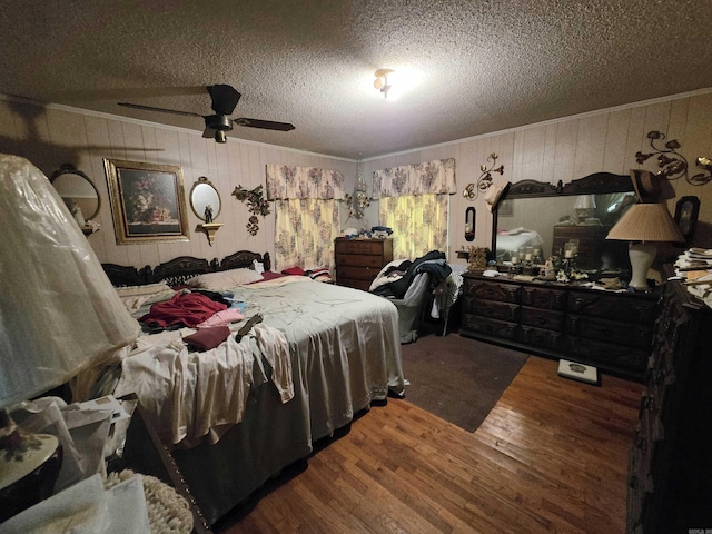 604 N Grand Ave, Mcrae, AR 72102 - bedroom with wood walls, a textured ceiling, wood finished floors, and ornamental molding