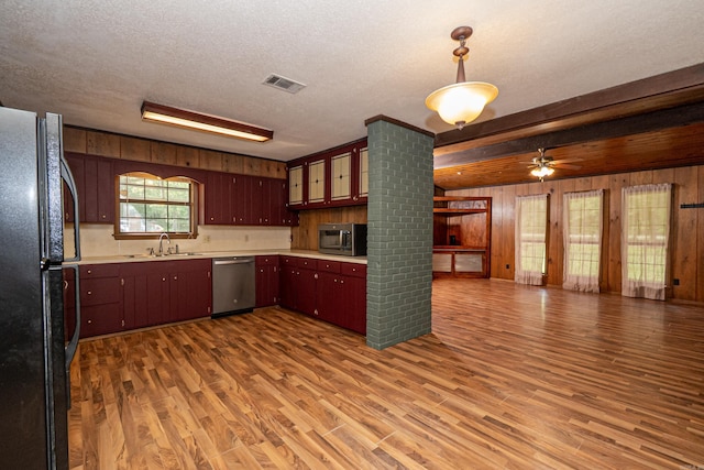 43 Calhoun 11, Hampton, AR 71744 - kitchen featuring appliances with stainless steel finishes, wood walls, a sink, visible vents, and open floor plan