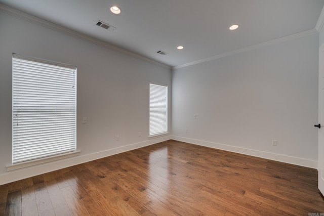 spare room with crown molding, baseboards, recessed lighting, and visible vents