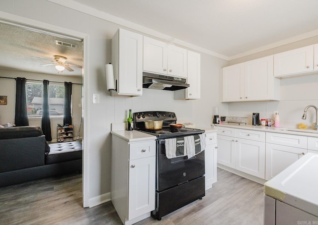 kitchen with white cabinets, a sink, black electric range oven, under cabinet range hood, and visible vents