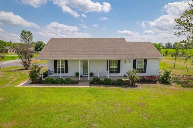 view of front of property featuring a porch, a front lawn, and roof with shingles