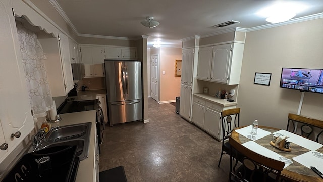 kitchen featuring crown molding, light countertops, a sink, white cabinets, and stainless steel appliances