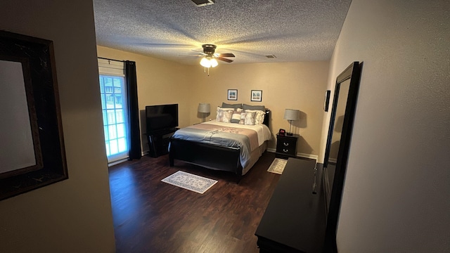 bedroom featuring a textured ceiling, ceiling fan, wood finished floors, and visible vents
