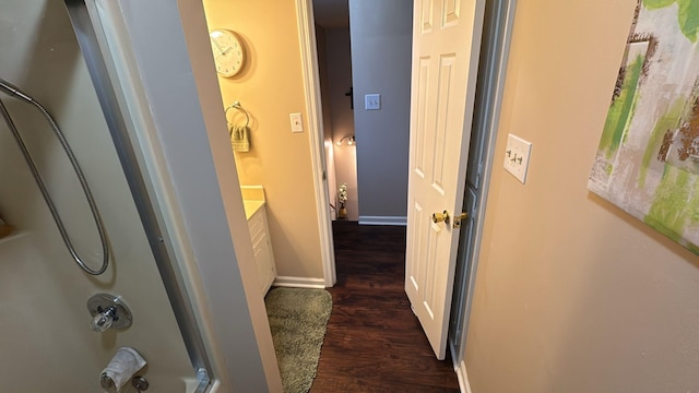 hall with baseboards and dark wood-style floors