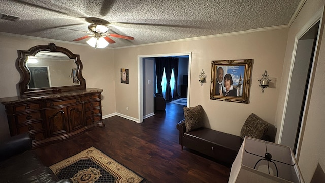 corridor featuring a textured ceiling, visible vents, ornamental molding, and wood finished floors