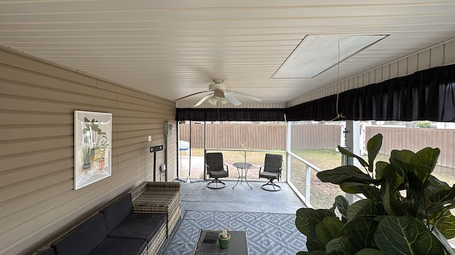 sunroom with a ceiling fan