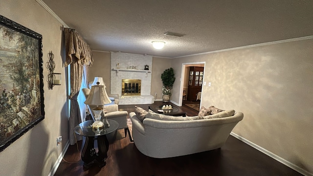 living area with a brick fireplace, a textured ceiling, baseboards, and visible vents