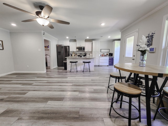 505 E Mississippi St, Beebe, AR 72012 - dining area featuring ornamental molding, light wood-style flooring, a ceiling fan, recessed lighting, and baseboards
