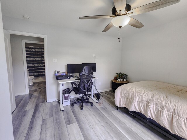 505 E Mississippi St, Beebe, AR 72012 - bedroom featuring wood finished floors, an office area, a ceiling fan, and baseboards