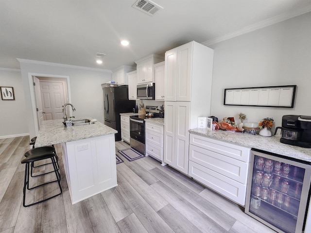 505 E Mississippi St, Beebe, AR 72012 - kitchen with appliances with stainless steel finishes, a sink, wine cooler, ornamental molding, and white cabinets